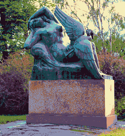A picture of the Ilmatar ja sotka statue. It depicts a nude figure, sitting, throwing their head and arms back while a bird sits on their lap, wings wide open.